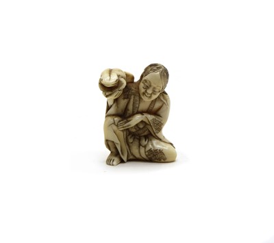 Lot 170 - A Japanese ivory netsuke of a seated man and Frog