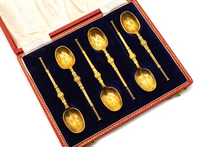 Lot 38 - A cased set of six silver gilt anointing spoons