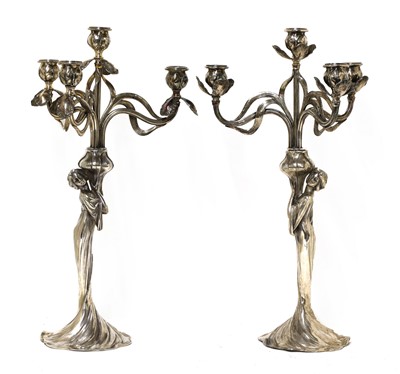 Lot 109 - A matched pair of WMF silvered four-branch figural candelabra