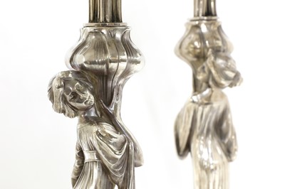 Lot 109 - A matched pair of WMF silvered four-branch figural candelabra