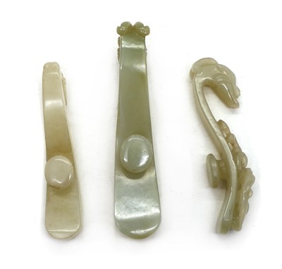 Lot 129 - A collection of three Chinese jade belt hooks