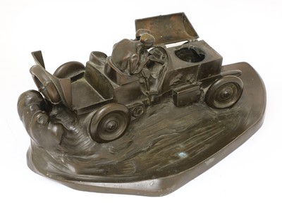 Lot 101 - A Kayser patinated spelter desk stand in the form of a racing car