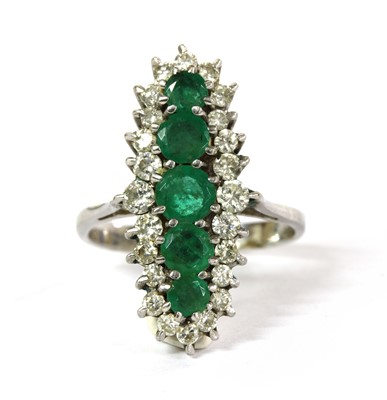 Lot 232 - A white gold emerald and diamond fingerline cluster ring