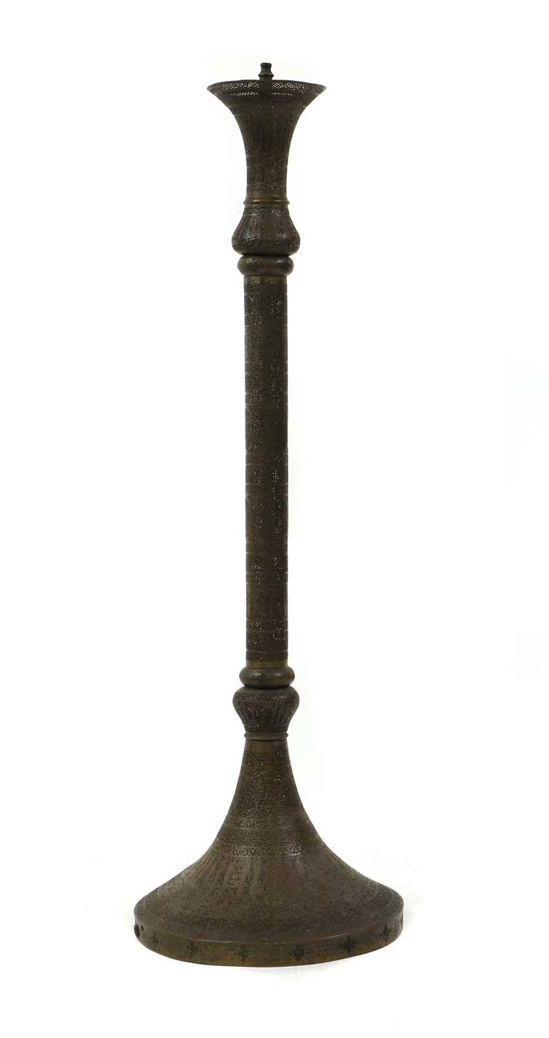 Lot 609 - An Islamic pierced brass floor standing mosque lamp