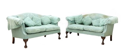 Lot 600 - A pair of Chippendale style camelback sofas