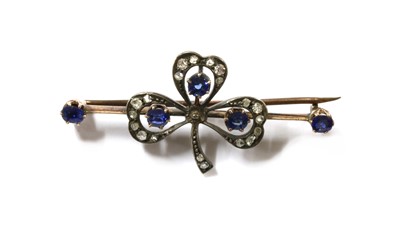 Lot 31 - A silver and gold, sapphire and diamond shamrock brooch