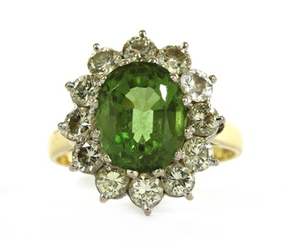 Lot 244 - A gold peridot and diamond cluster ring