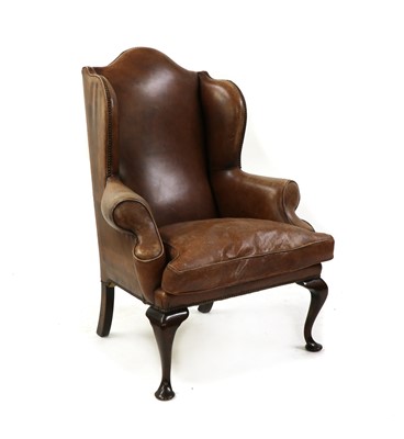 Lot 487 - A Queen Anne style studded leather wing armchair