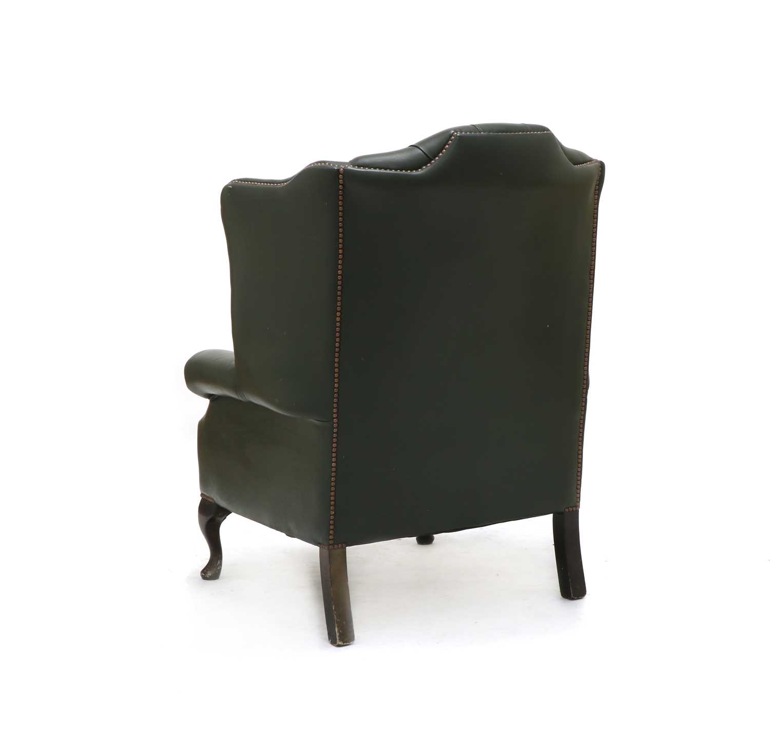 Lot 604 A green leather upholstered wing back