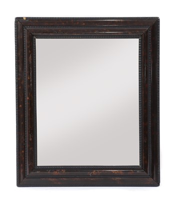 Lot 513 - A Dutch-style imitation tortoiseshell and ebonised mirror