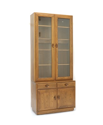 Lot 571 - An Ercol elm 'Windsor' display cabinet