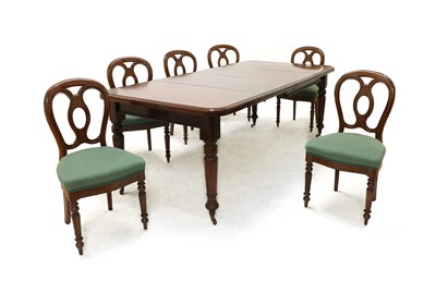 Lot 597 - A Victorian walnut dining table and a matched set of six oak dining chairs