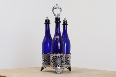 Lot 707 - A Victorian silver bottle stand with three blue bottles