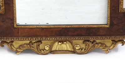 Lot 514 - A pair of George II-style walnut and parcel-gilt pier mirrors