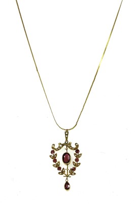 Lot 55 - An Edwardian gold garnet and split pearl pendant