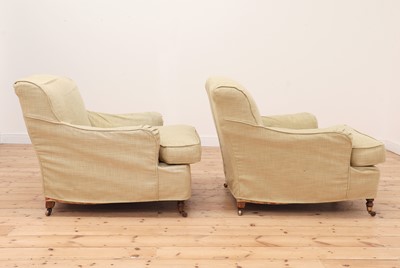 Lot 540 - A pair of Howard-style armchairs by George Smith