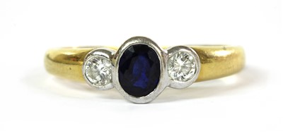 Lot 269 - An 18ct gold three stone sapphire and diamond ring