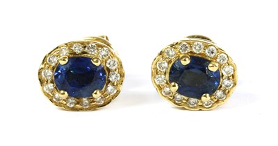 Lot 264 - A pair of gold sapphire and diamond cluster earrings