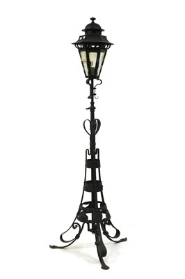 Lot 191 - An Arts and Crafts wrought iron standard lamp