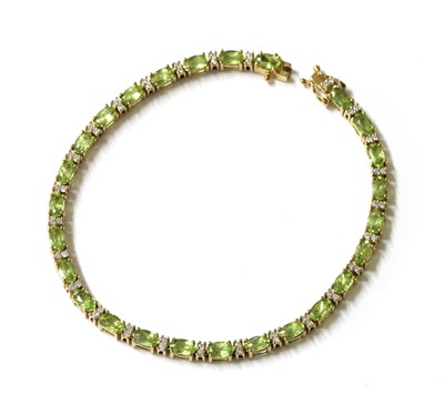 Lot 245 - A gold peridot and diamond line bracelet