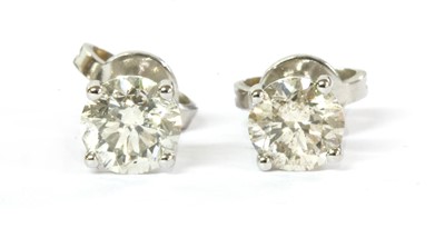 Lot 190 - A pair of white gold single stone diamond stud earrings