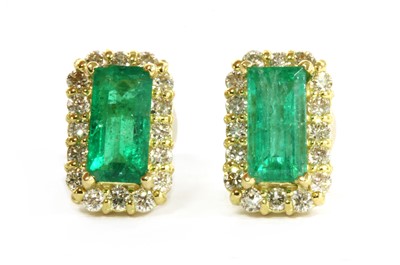 Lot 228 - A pair of gold emerald and diamond cluster earrings