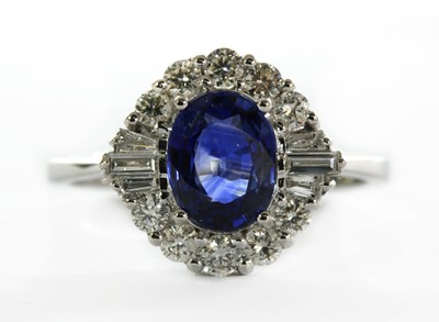 Lot 251 - A white gold sapphire and diamond cluster ring