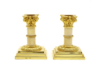 Lot 152 - A pair of ormolu & ivory candlesticks