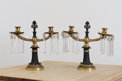 Lot 779 - A pair of bronze and gilt-bronze twin-branch candelabra