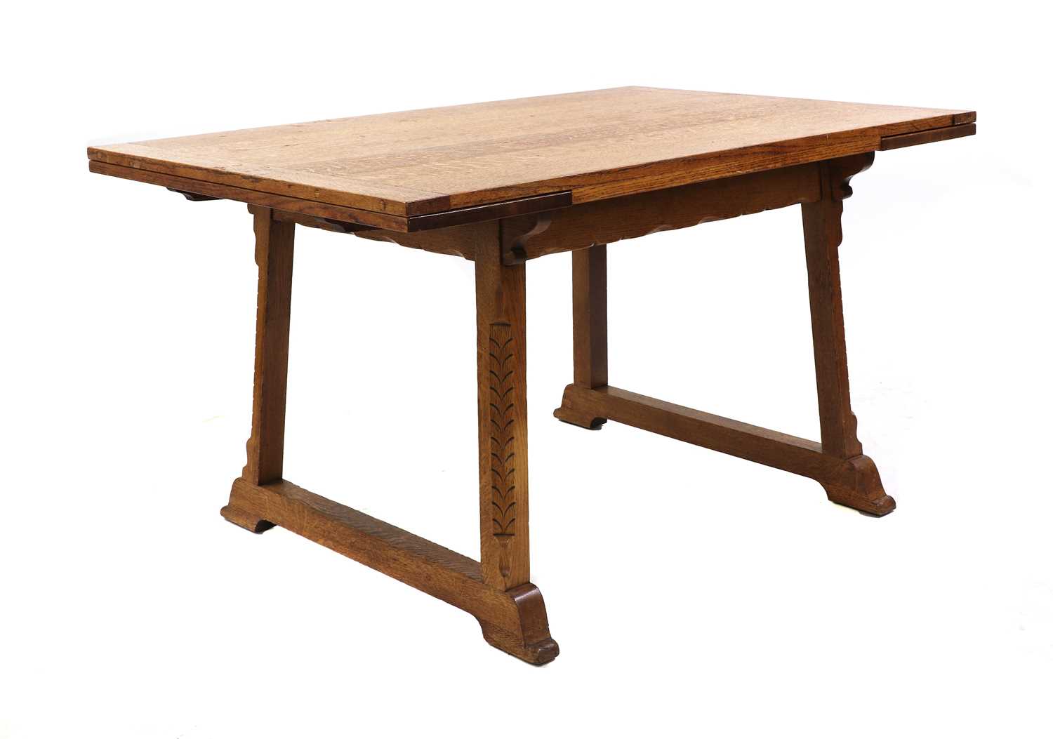 Lot 224 - An Arts and Crafts oak extending dining table
