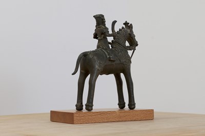Lot 154 - A folk bronze of a rider on horseback