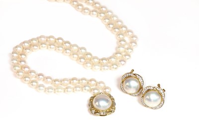 Lot 250 - A cultured pearl and diamond two row uniform necklace and matched earring suite