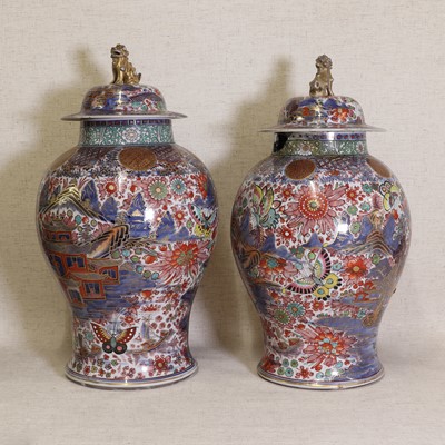 Lot 44 - Two Chinese clobbered blue and white vases and covers