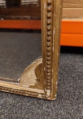 Lot 436 - A slender gilt framed wall mirror