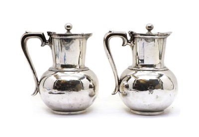 Lot 79 - A pair silver plated hot water jugs