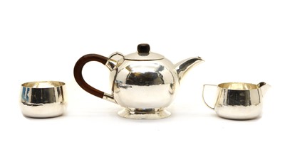 Lot 59 - A mid-century faintly planished three piece tea service