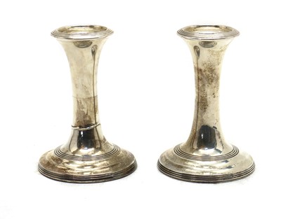 Lot 42 - A pair of Edwardian silver dwarf candlesticks