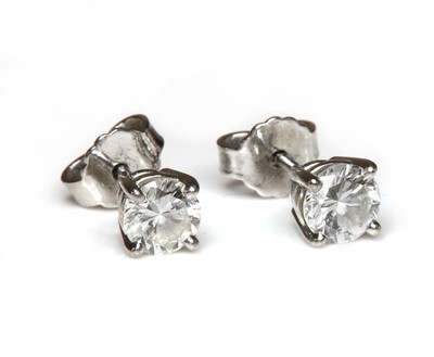 Lot 133 - A pair of platinum single stone diamond stud earrings