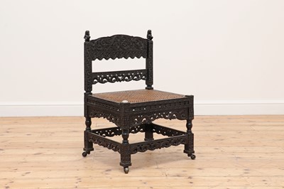 Lot 714 - A carved ebony low chair