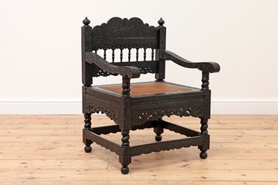 Lot 715 - A finely carved ebony armchair