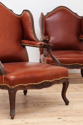 Lot 759 - A pair of leather-upholstered wing armchairs