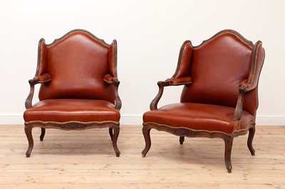 Lot 759 - A pair of leather-upholstered wing armchairs