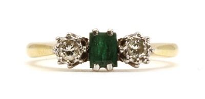 Lot 165 - An 18ct gold three stone emerald and diamond ring