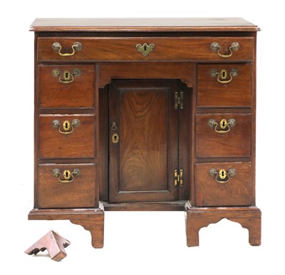 Lot 525 - A George II mahogany kneehole desk