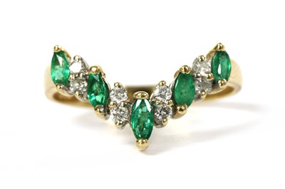 Lot 230 - A 14ct gold emerald and diamond wishbone ring