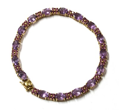 Lot 304 - A 9ct gold amethyst and gem set bracelet