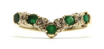 Lot 171 - A 9ct gold emerald and diamond wishbone ring