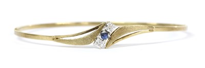 Lot 272 - A 9ct gold sapphire and diamond bangle