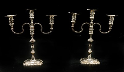 Lot 9 - A pair of twin-branch cast silver candlesticks