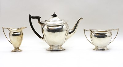 Lot 11 - A George III style three piece silver tea set
